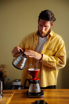 Man Pouring Coffee With Pour-Over Kettle at Home