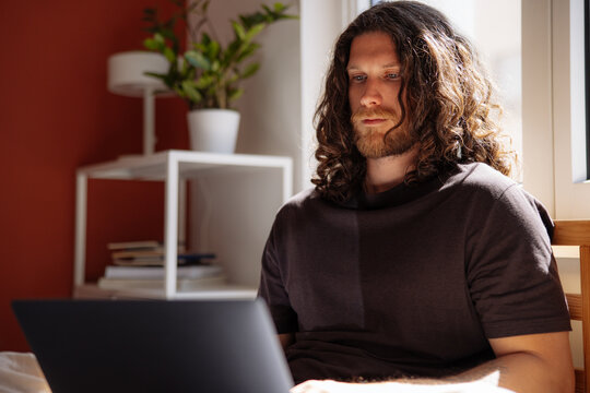 Focused Man Working on Laptop