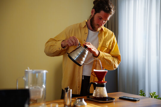 Man Pouring Coffee With Pour-Over Brewer 
