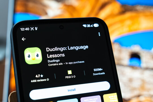 Warsaw, Poland - July 6, 2026: Close-up of a smartphone displaying the Duolingo language learning app, showcasing its interface, reviews, and download information.