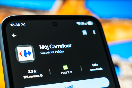 Warsaw, Poland - July 6, 2026: Smartphone screen displaying 'Moj Carrefour' app with user interface showing ratings and download information for Carrefour Polska grocery store