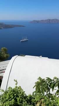 White architecture in Santorini island, Greece. Blue sea and the blue sky at sunny day. Luxury resort. Travel and summer vacation concept. Vertical video
