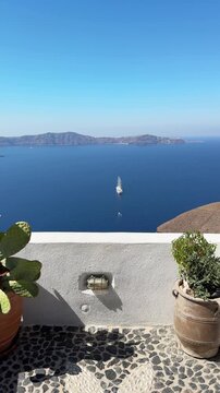 White architecture in Santorini island, Greece. Blue sea and the blue sky at sunny day. Luxury resort. Travel and summer vacation concept. Vertical video
