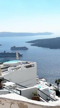 White architecture in Santorini island, Greece. Blue sea and the blue sky at sunny day. Luxury resort. Travel and summer vacation concept. Vertical video
