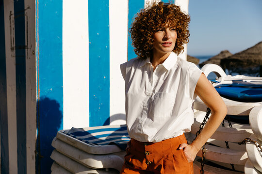 Curly haired woman at beach club