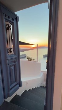Beautiful sunset in Santorini island, Greece. White architecture with sea view. Blue sea and the blue sky at sunset. Summer travel and vacation. Vertical video
