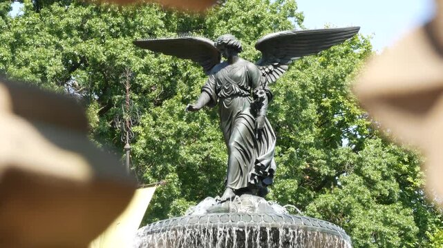 New York City Central Park Bethesda Fountain, angel statue by Bethesda Terrace on summer day, United States. Greenery and sculpture in morning. Autumn fall leaves and green trees in NYC Manhattan, USA