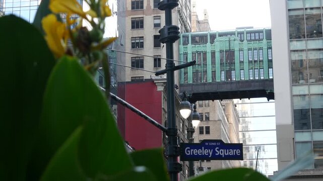 New York City Gimbels bridge, Manhattan Midtown, United States of America. Skybridge on Broadway, Herald Square, USA. Gimbels traverse on 6 avenue. Historic elevated walkway 1925. Greeley Square sign.