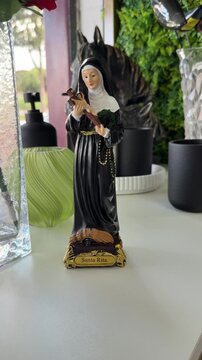 Statue of Saint Rita holding crucifix