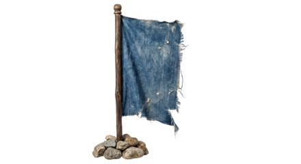 Fototapeta premium Tattered blue fabric flag on wooden pole with stones at base