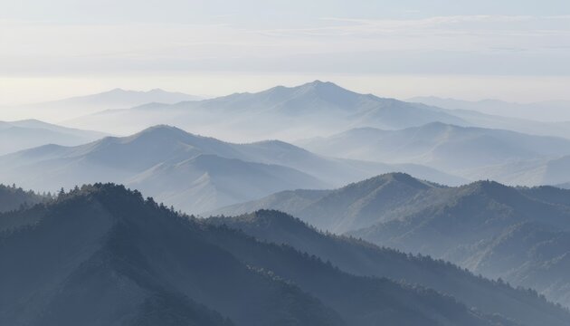 Blue-toned mountains fade in misty layers