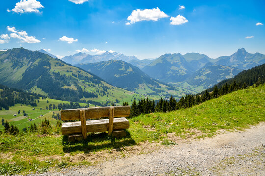 Wooden bench at a viewpoint over an alpine valley