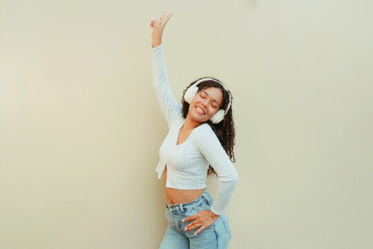 Young woman enjoying music with headphones smiling brightly