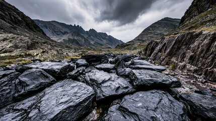 Obraz premium Dramatic Rocky Mountain Pass With Wet Black Stones And Storm Clouds