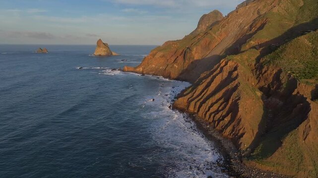 Aerial drone footage of Roque de Dentro at sunset on the northern coast of Tenerife, Canary Islands, Spain