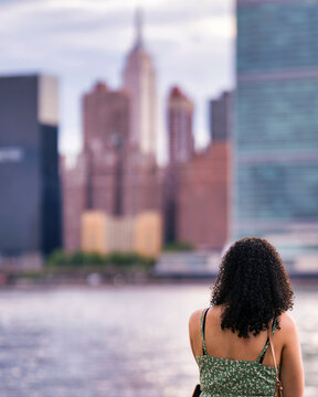 Woman Looking at Manhattan Skyline from Brooklyn Waterfront