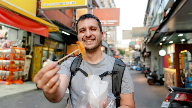 Traveler enjoying street food at Fengjia Night Market