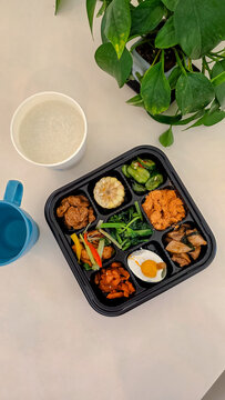 Bento box breakfast with diverse food items