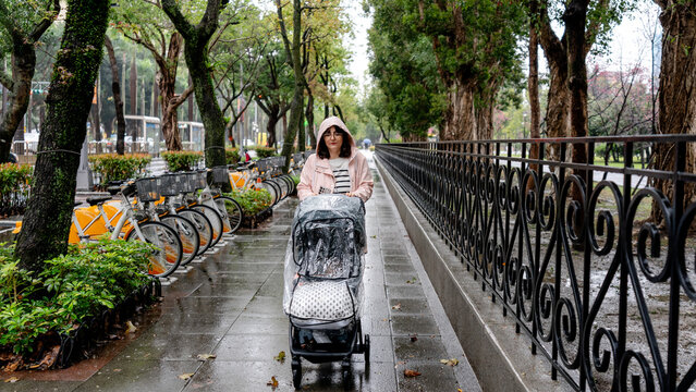 Mother with stroller on rainy day in Taipei