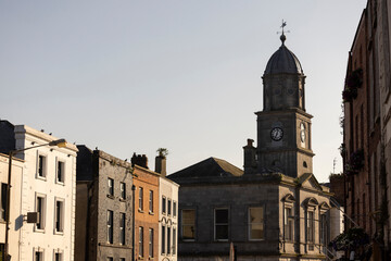 Fototapeta premium Late afternoon sun illuminates a historic street in the city centre of Drogheda, County Louth, Ireland.