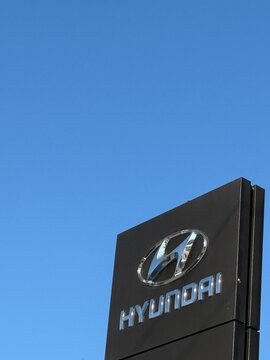 Hyundai logo on building facade against clear blue sky background