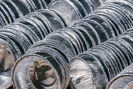 Stack of empty aluminum foil containers. Household waste ready for sorting and recycling. Sustainable lifestyle and waste management concept for environmental protection and ecology.