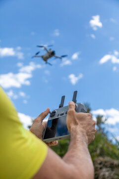 Remote control drone flight in blue sky with clouds
