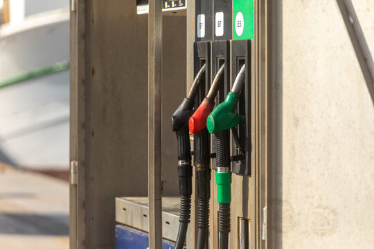 Fuel pump nozzles at gas station for vehicle refueling