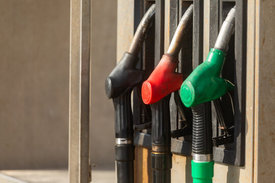 Close-up of fuel pump nozzle lineup at service station