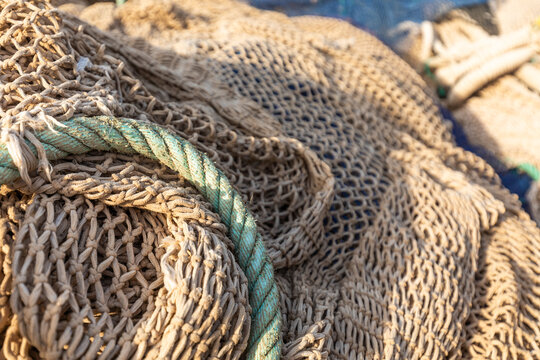 Close-up of fishing net and rope texture on dock