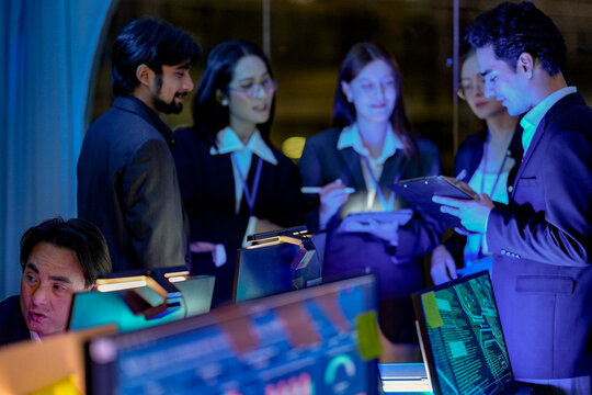 Multicultural team writing code by the glow of the screens in a neon-tinged tech loft, double-checking results, in a scene about data and cool cinematic glow in a professional setting.