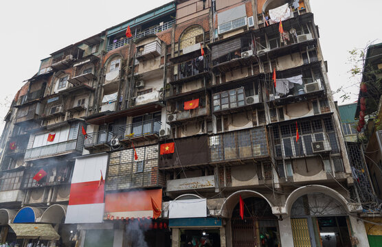 Urban architecture in Hanoi with vibrant flags