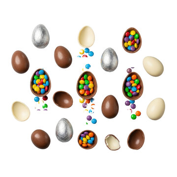 Variety of whole and broken chocolate easter eggs spilling colorful candies and star sprinkles on a gray surface overhead festive easter celebration atmosphere