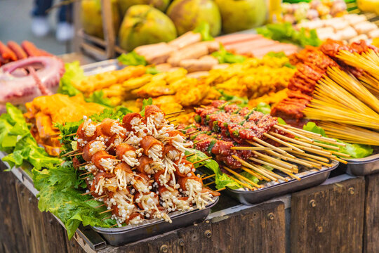 Vietnamese street food skewers and seafood at market stall