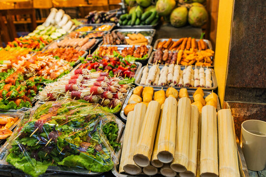 Vibrant Vietnamese street food stall with fresh produce spread