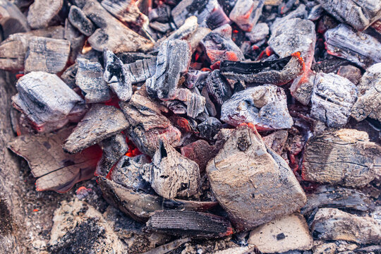 Close-up of glowing charcoal embers for summer barbecue