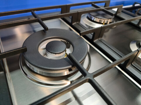 Modern kitchen gas stove displayed in a hardware supermarket showroom, clean appliance with burners and oven, designed for home cooking and everyday use, retail environment concept
