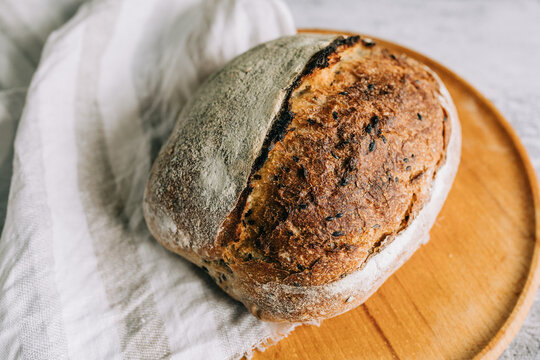 Rustic artisan bread loaf with organic ingredients on board