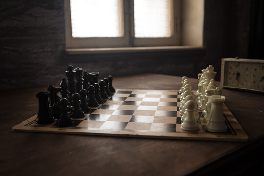 Chess board game concept of business ideas and competition and strategy ideas concep. Chess figures on a dark background with smoke and fog. Selective focus