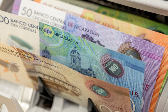 Nicaragua money. Cordoba banknotes in a currency counting machine. Financial market, Nicaraguan economy, economic concept. Business background