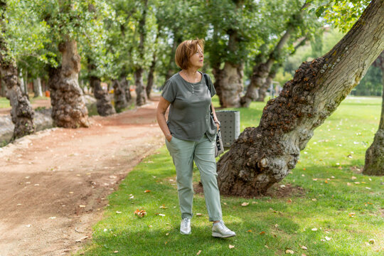 Senior woman walking in park enjoying active retirement