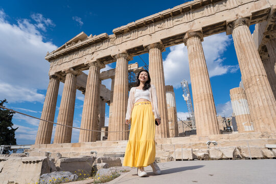 Woman visiting Parthenon temple ruins in Athens, Greece