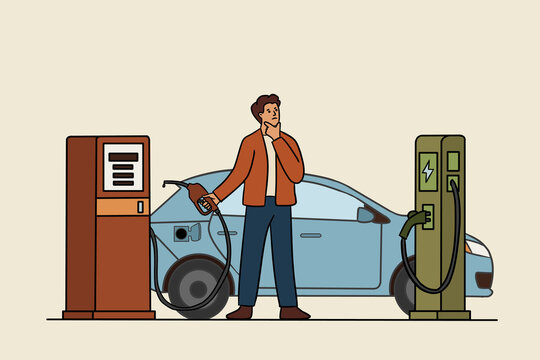 Driver choosing between gas and electric car charging station