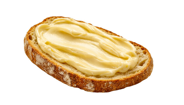 Slice of rustic bread with smooth yellow butter spread, isolated on transparent background. Simple breakfast concept.