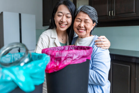 Asian family recycling together at home, Smiling in kitchen