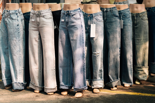 Jeans display on mannequin legs with price tags in store