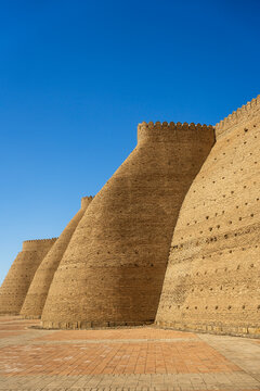 Ancient Ark of Bukhara fortress walls under clear sky