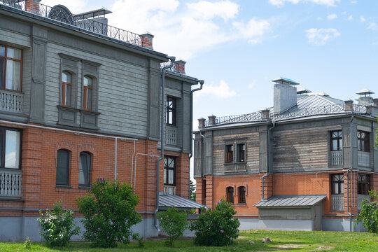 Historic wooden apartment buildings with brick facade and balcony
