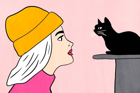 Woman in yellow beanie looking at black cat in love