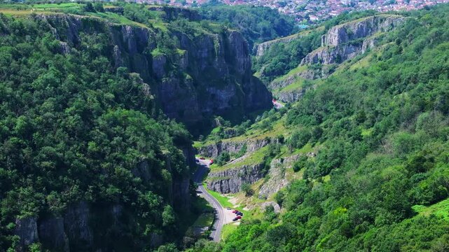 Tracking telephoto aerial shot of Cheddar Gorge in Somerset, UK